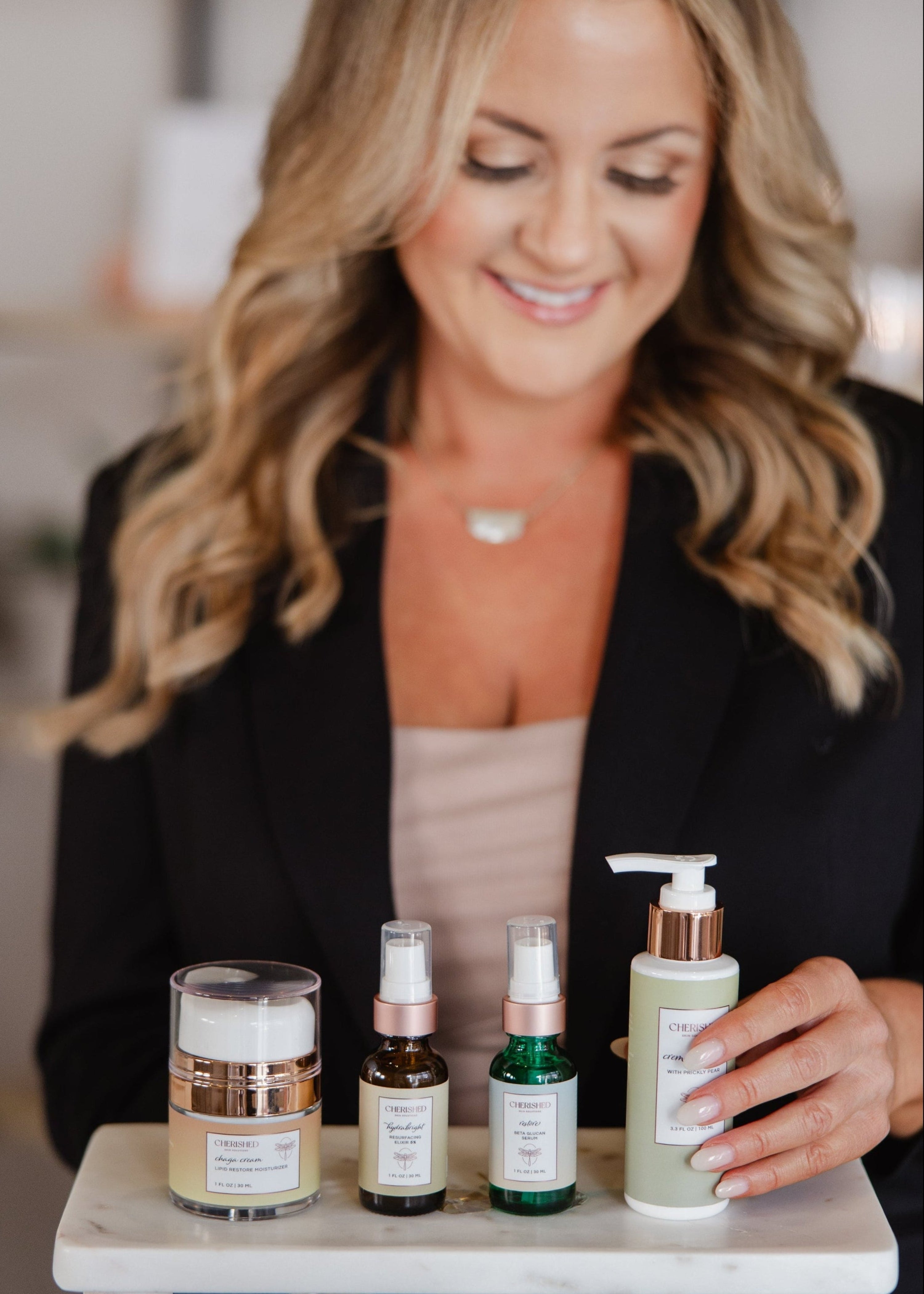Woman holding a tray with skincare products in an indoor setting